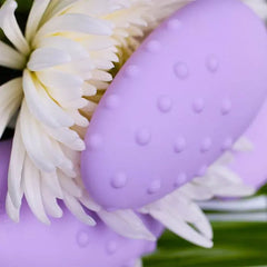 Close-up of Mimi Deux raised silicone nubs beside a white chrysanthemum bloom
