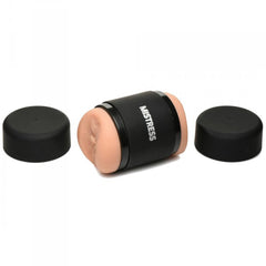 Mistress Double Shot Stroker disassembled with two protective black caps beside the sleeve