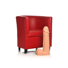 Moby 2 Foot Super Dildo in light tone standing beside a red armchair for size reference