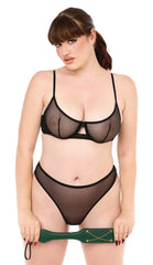 Model holding green Indica paddle at waist level, showing paddle size relative to the human form