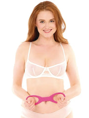 Model holding Sex & Mischief silicone cuffs at waist, showing wearable oval loop size