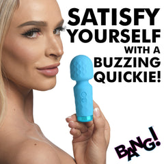 Model holding sky-blue Bang! mini wand vibrator at chin level, showcasing compact handheld size