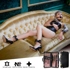 Model wearing Temptasia wrist and ankle cuffs with ball gag on velvet sofa; soft vegan leather construction