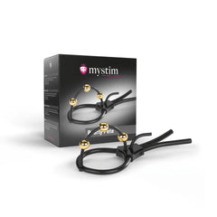Mystim Pearly Pete corona strap beside its dark product box, showing scale and gold bead detail