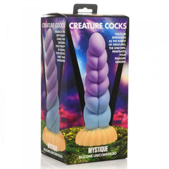 Mystique silicone unicorn dildo beside its retail box showing front and back packaging
