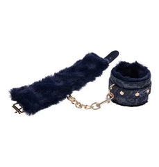 Navy fur-lined handcuffs laid flat showing gold chain connector and adjustable strap length