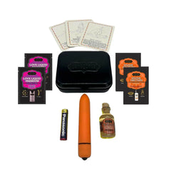 Nine-piece Weekender Kit contents laid flat: orange bullet vibe, body oil, lubricant sachets, and position cards