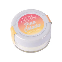 Nipple Nibblers Pina Colada cocktail balm in closed white lidded glass jar, angled view