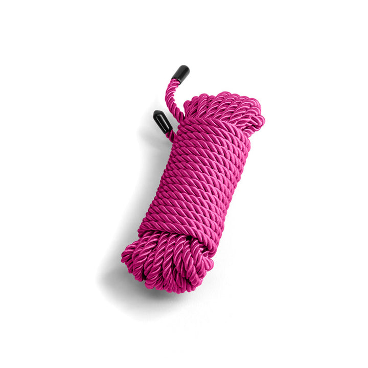 NS Novelties Bound pink twisted nylon rope coiled neatly with black end caps, 25 ft