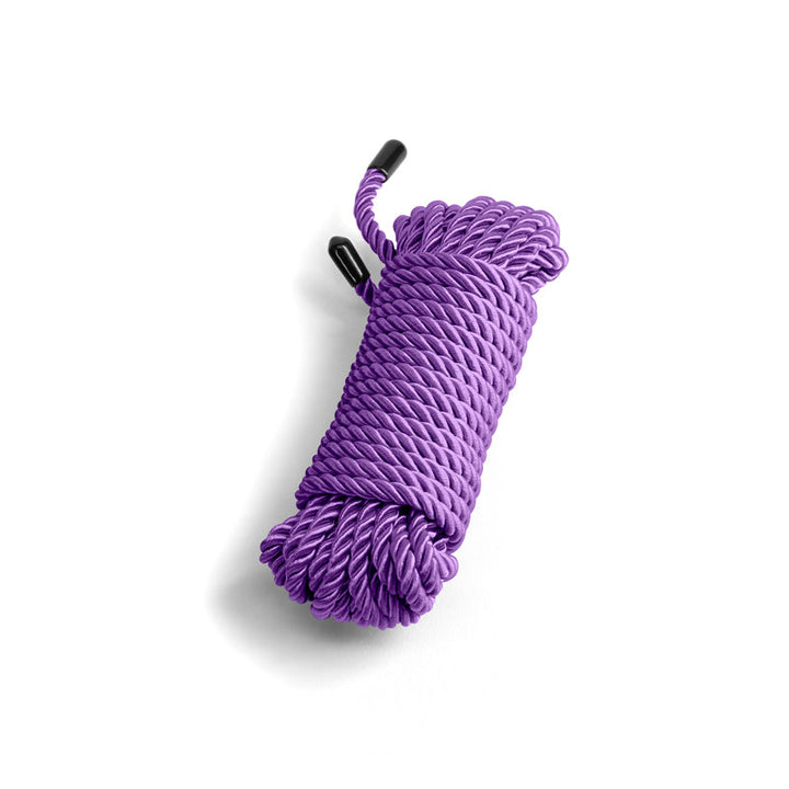NS Novelties Bound purple twisted cotton rope coiled neatly with black end caps, 25ft