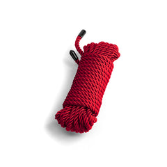 NS Novelties Bound red twisted rope coiled neatly with black-tipped ends, 25 ft