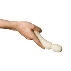 One hand gripping the flexible neck of the Dame Min Mini Wand, showing bend and soft silicone