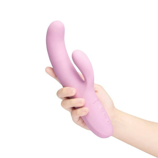One hand holding Le Wand Hither pink rabbit vibrator upright, showing full size and button placement