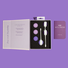 Open Blush Wellness kegel kit box showing foam-fitted balls, two trainers, and included guidebook