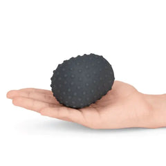 Open palm displaying the dotted charcoal silicone texture cover, revealing raised nub pattern