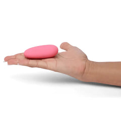 Open palm displaying Je Joue ILY Pebble vibrator, illustrating hand-sized fit