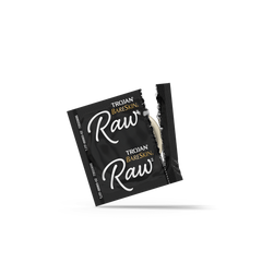 Open Trojan BareSkin Raw individual foil wrapper in black, showing lubricated latex condom inside