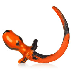 Opposite side view of orange black bulldog plug highlighting rounded insertable head and tail curve