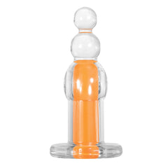 Orange Dream anal plug front view showing clear body with stacked ball tip and orange inner core
