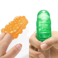 Orange Topaz and green Emerald Uni sleeves shown worn on fingers, highlighting flexible fit