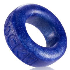 Close-up of Oxballs COCK-T blue glitter silicone cockring showing embossed brand lettering