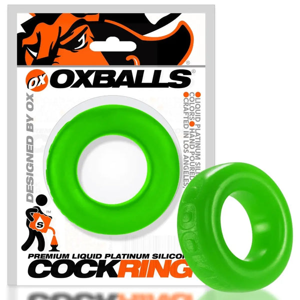 Oxballs COCK-T slime green cock ring beside its retail packaging, showing relative size and profile