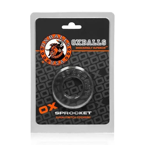 Oxballs Sprocket Cock Ring in clear, shown in retail blister packaging on branded card