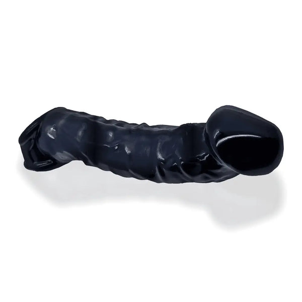 Oxballs Muscle Bandit black silicone cocksheath lying flat, showing curved realistic shape