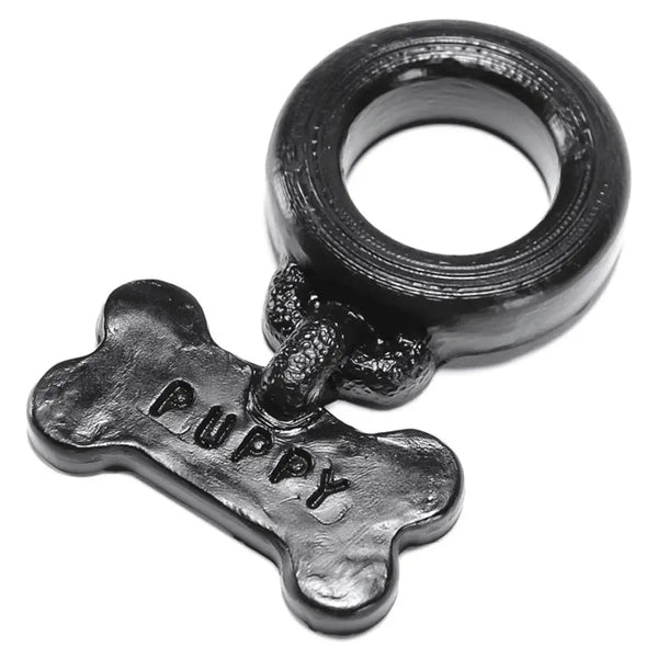 Oxballs Puppy Silicone Cockring in black with embossed bone-shaped charm tag