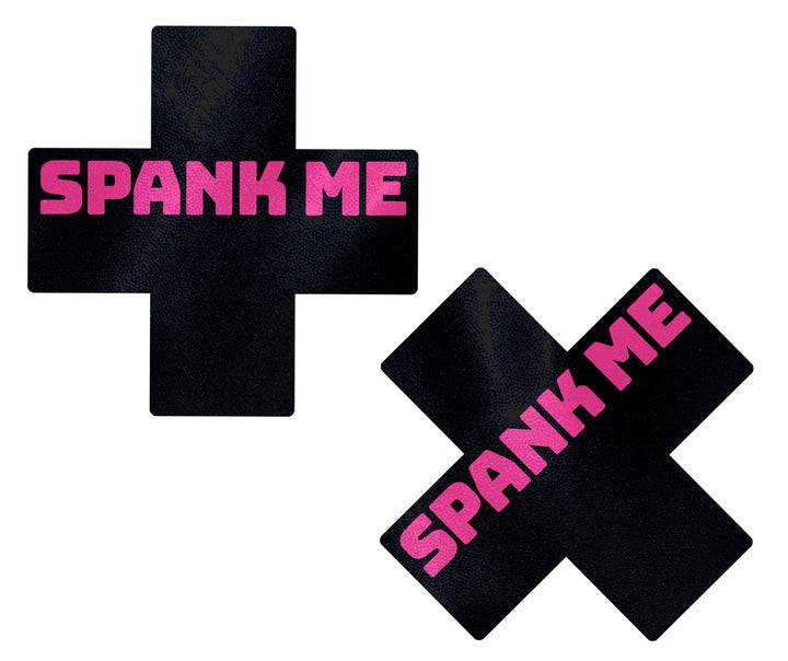 Pastease black faux-leather cross and X-shape pasties with pink 'Spank Me' text