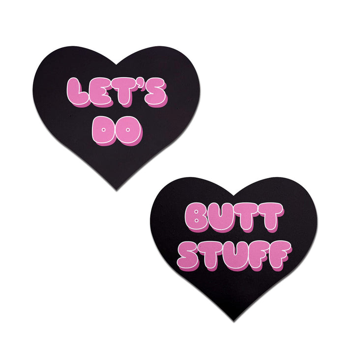 Pastease black heart-shaped pasties with pink bubble-letter 'Let's Do Butt Stuff' text, pair