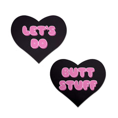 Pastease black heart-shaped pasties with pink bubble-letter 'Let's Do Butt Stuff' text, pair