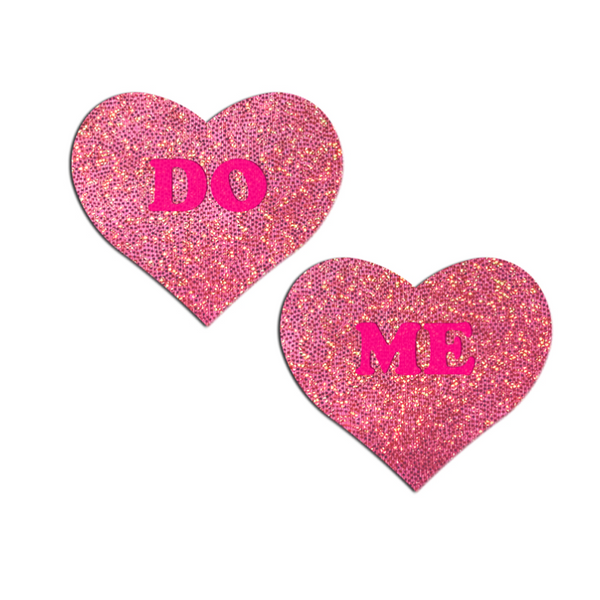 Pastease pink glitter heart pasties with bold 'DO ME' text in hot pink lettering