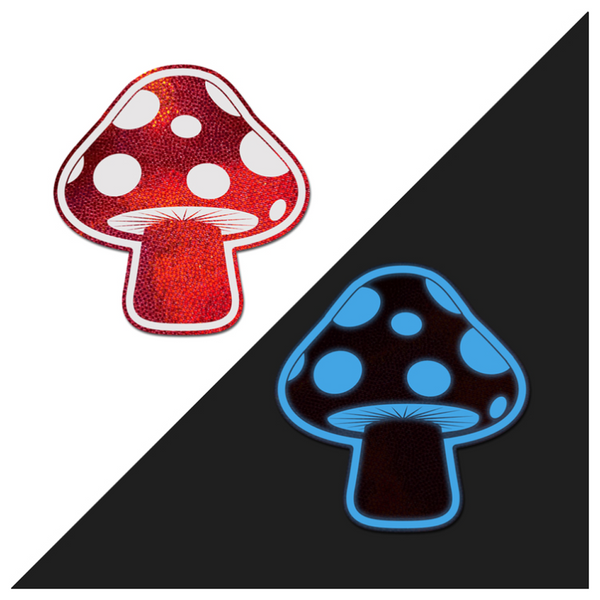 Pastease red holographic mushroom pasties shown normally and glowing blue in the dark