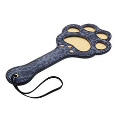 Close-up of paw paddle handle featuring gold rivets, wrist loop, and leopard texture