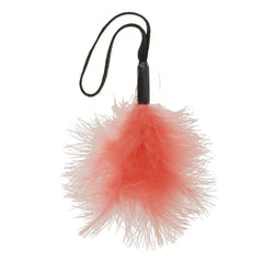 Peach Wrist Feather Tickler showing fluffy coral feather pom and black handle with wrist loop