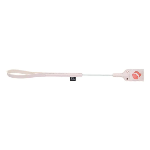 Peaches n CreaMe Crop laid flat displaying coral embossed paddle end and wrist loop handle