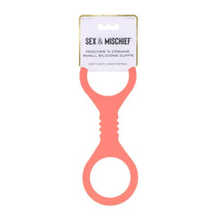 Peaches n CreaMe Silicone Cuffs shown in retail packaging, soft coral color