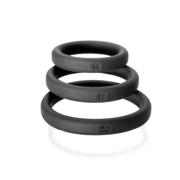 Perfect Fit Xact-Fit three black silicone cock rings stacked, sized 14, 17, and 20