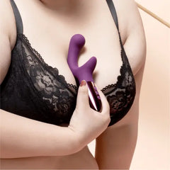 Person in black lace bra holding Le Wand XO purple silicone rabbit vibrator