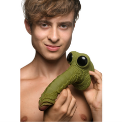 Person holding Creature Cocks Swamp Monster dildo showing size reference and textured green silicone