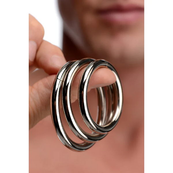 Person holding the Trine three-ring set together, showing smooth polished finish
