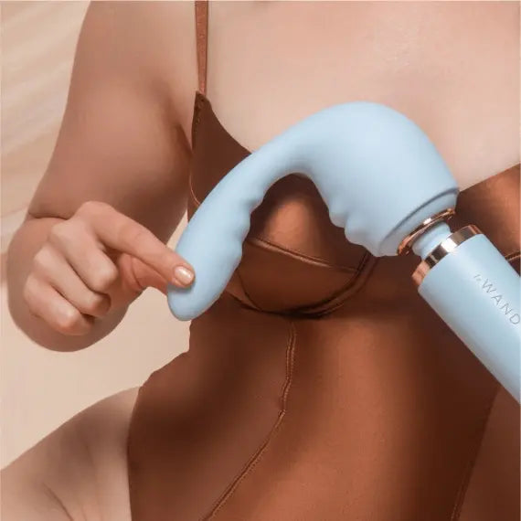 Person using Le Wand Flexi curved silicone attachment against shoulder and upper body area