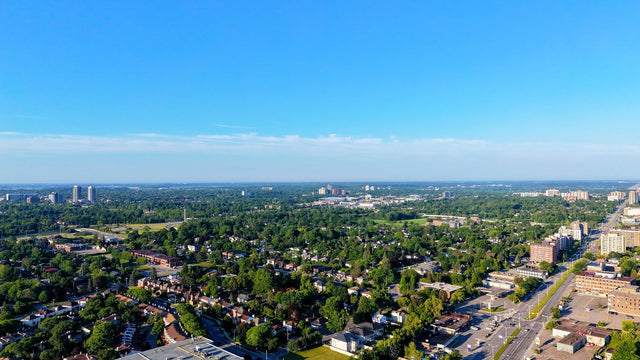 Aerial view of a leafy Ontario suburb with homes and trees under a clear summer sky