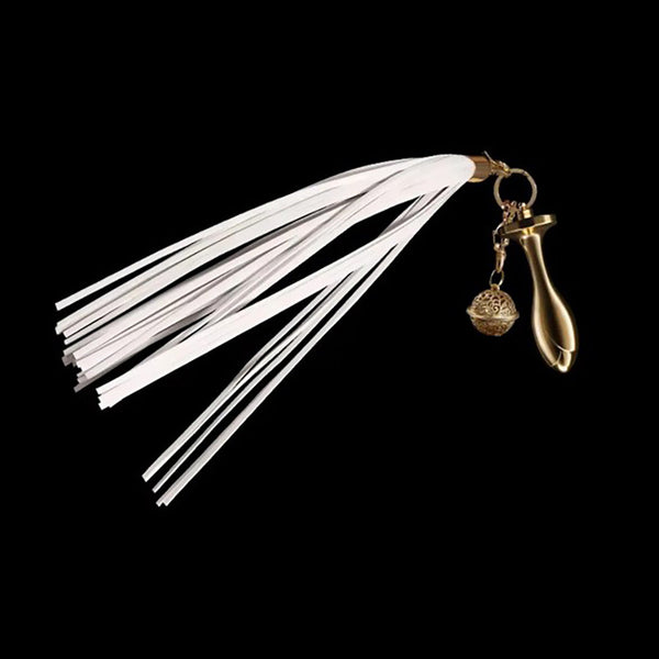 Pink Elephant white leather flogger tail plug kit with gold rose-shaped plug and filigree bell charm on black background