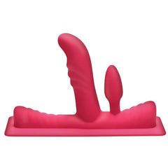 Pink silicone dual-penetration attachment with curved shaft and small plug on ribbed base