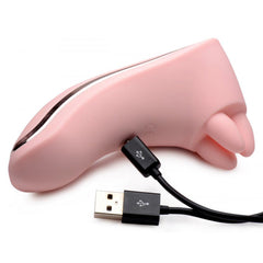 Pink Vibrassage Fondle massager lying flat with USB charging cable connected to base