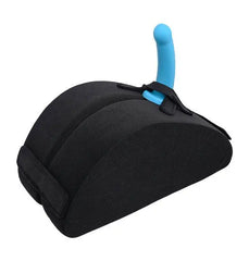 Pivot wedge cushion holding a blue silicone toy upright via adjustable strap attachment