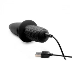 The Plug 10x vibrating thruster connected to USB magnetic charging cable, side view