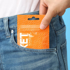 Pocket Tenga Hexa-Brick compact foil pack being slipped into a front jeans pocket